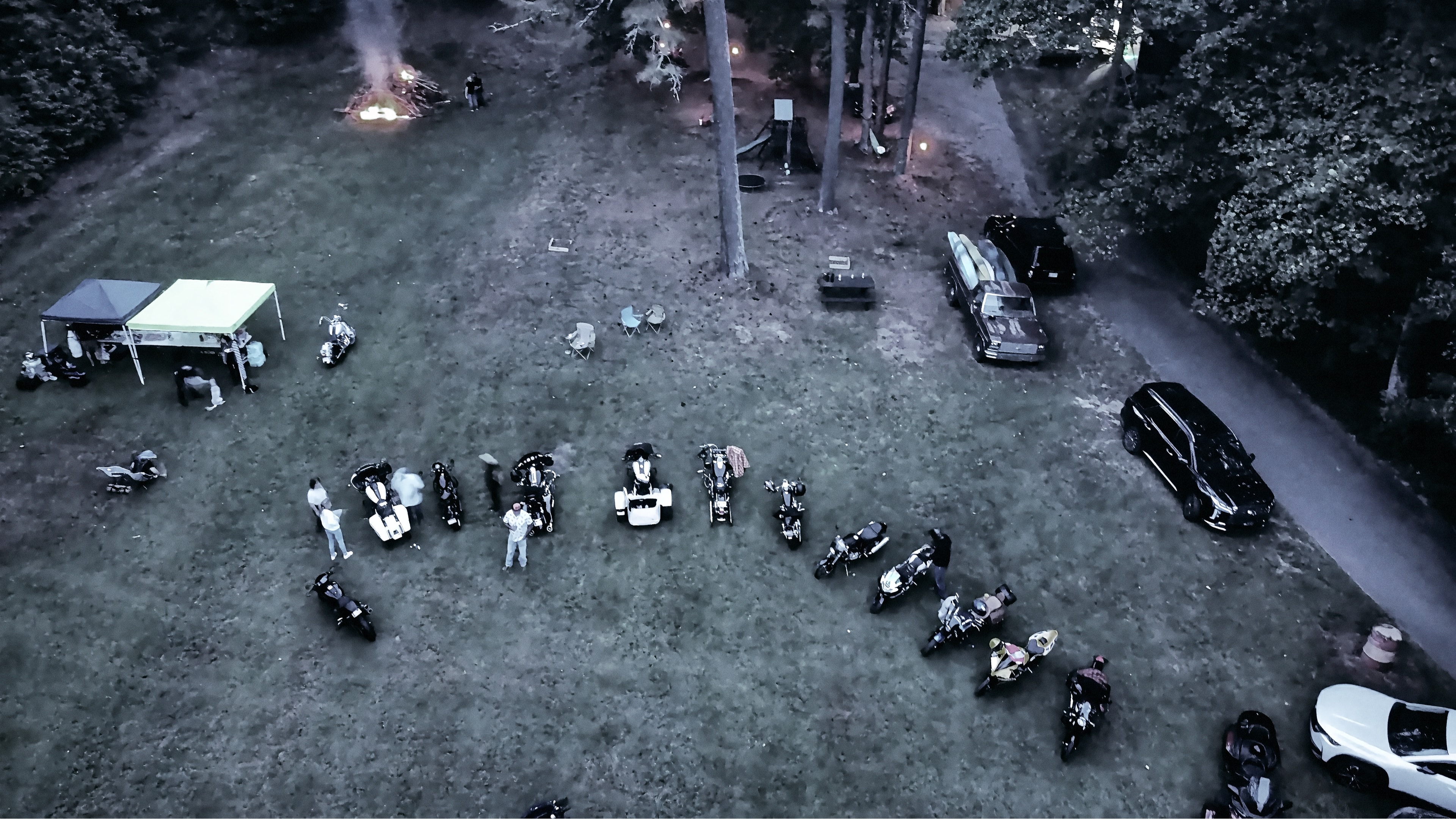 At Dug Hill — wide aerial view with string lights and forest treeline
